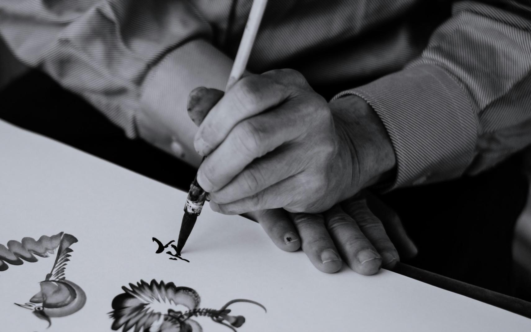 Artist working on life drawing with focused attention to detail